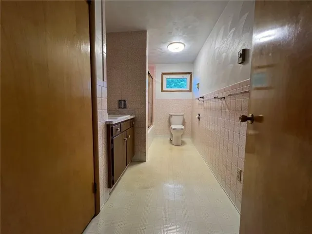 a en suite bathroom with a granite countertop sink and a mirror