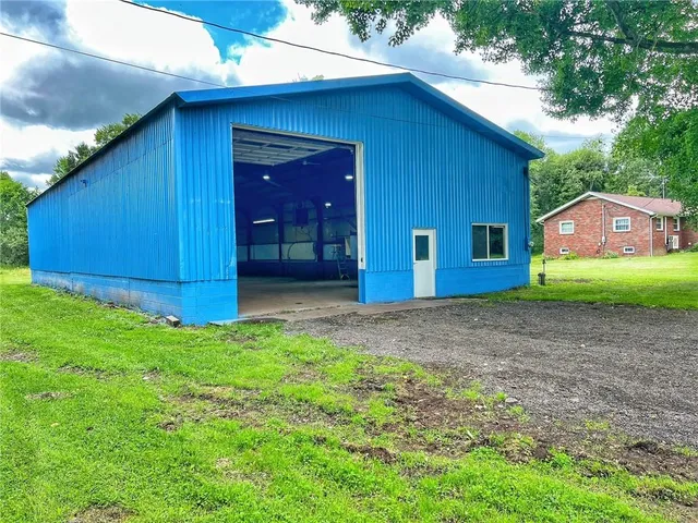 a view of a backyard with potted plants and wooden fence