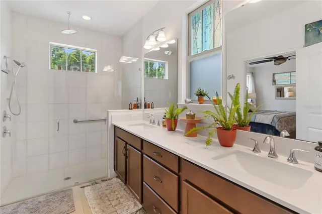 a living room with furniture a fireplace and a floor to ceiling window