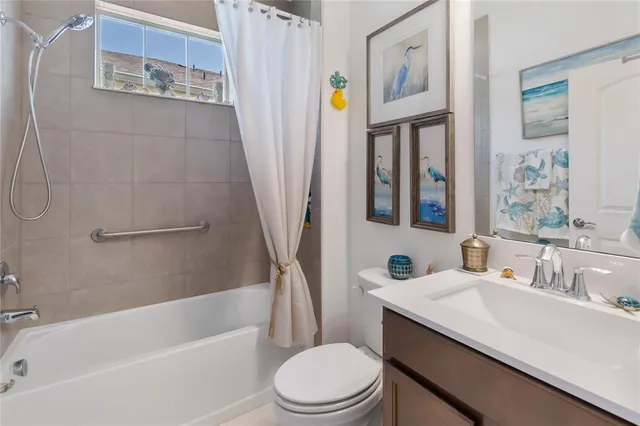 a living room with furniture kitchen view and a wooden floor