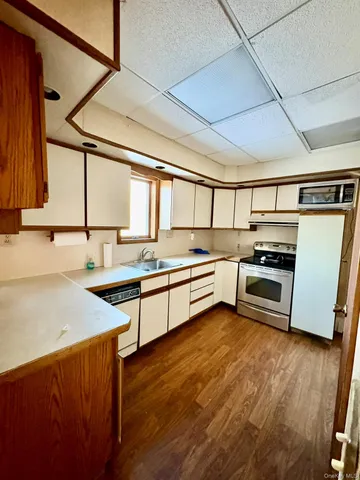 a kitchen with stainless steel appliances a stove a sink and a refrigerator