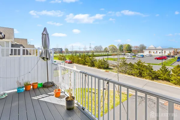 a view of a city from a balcony with furniture
