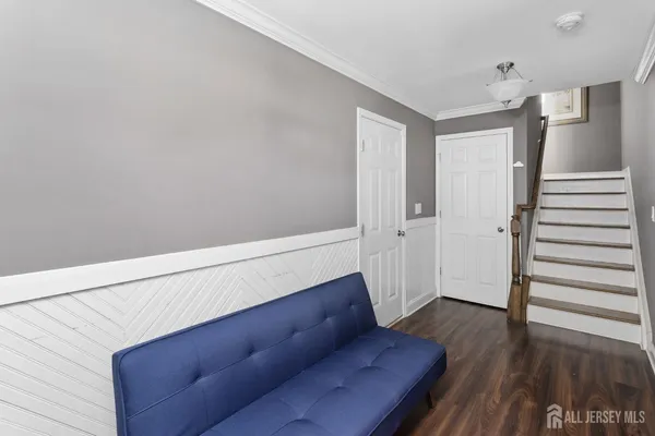 a living room with wooden floor and stairs