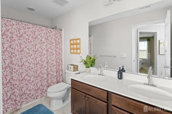 a bathroom with a sink a toilet and mirror