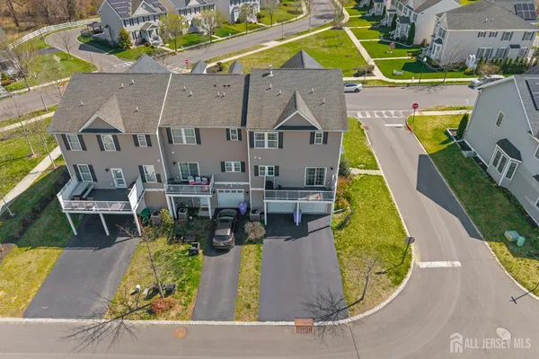 an aerial view of a house with swimming pool and sitting space