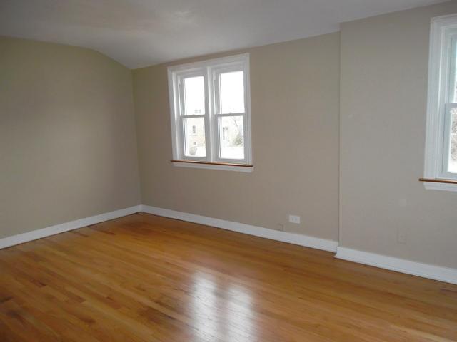 8118 West 26th Street North Riverside, IL 60546 - Photo 4 of 10 a view of an empty room with wooden floor and a window