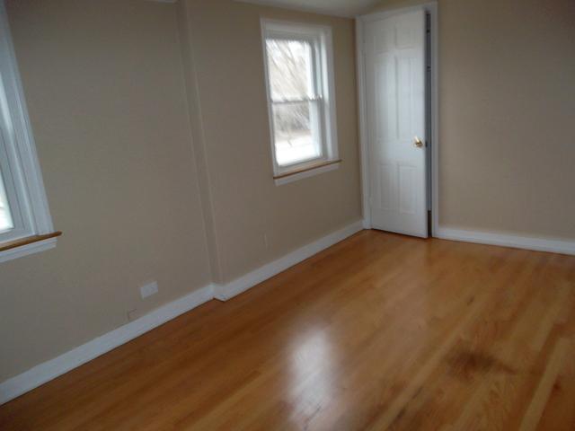 8118 West 26th Street North Riverside, IL 60546 - Photo 5 of 10 an empty room with wooden floor and windows