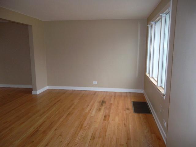 8118 West 26th Street North Riverside, IL 60546 - Photo 6 of 10 a view of an empty room with wooden floor and a window
