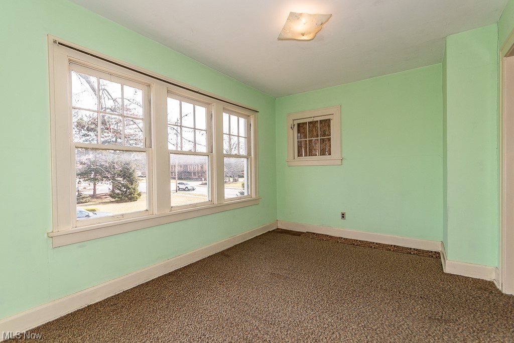29396 Detroit Road Westlake, OH 44145 - Photo 23 of 30 Spare room featuring dark colored carpet and a healthy amount of sunlight