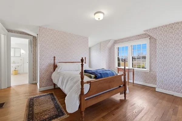 a bed room with a bed and a window