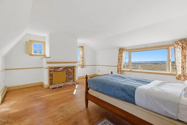 a bedroom with a bed and a fireplace