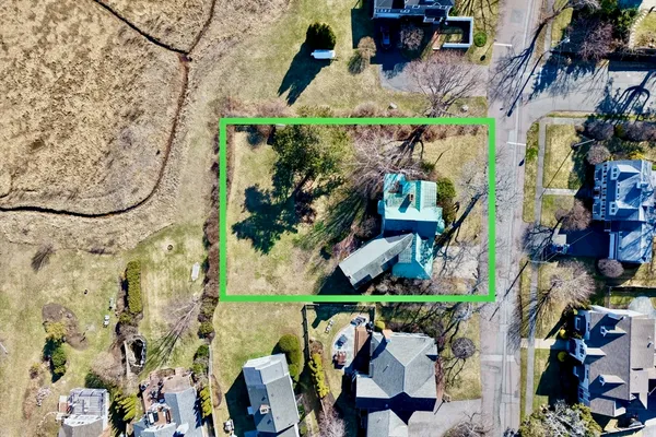 an aerial view of a houses with yard