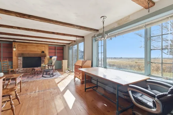 a living room with furniture a chandelier and a floor to ceiling window