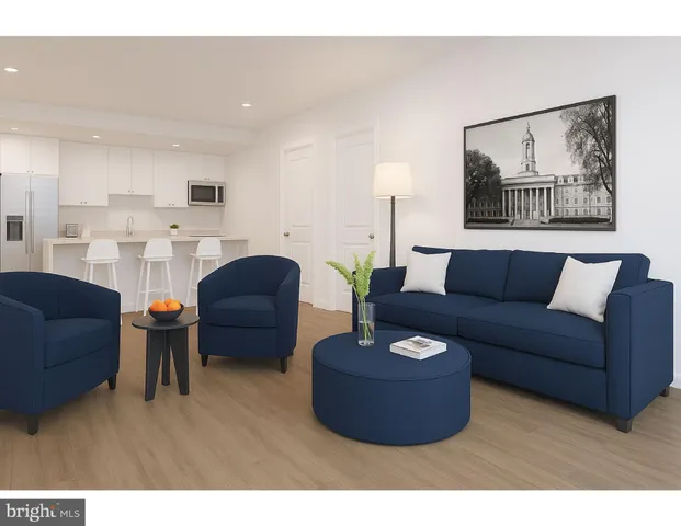 a living room with furniture and a painting