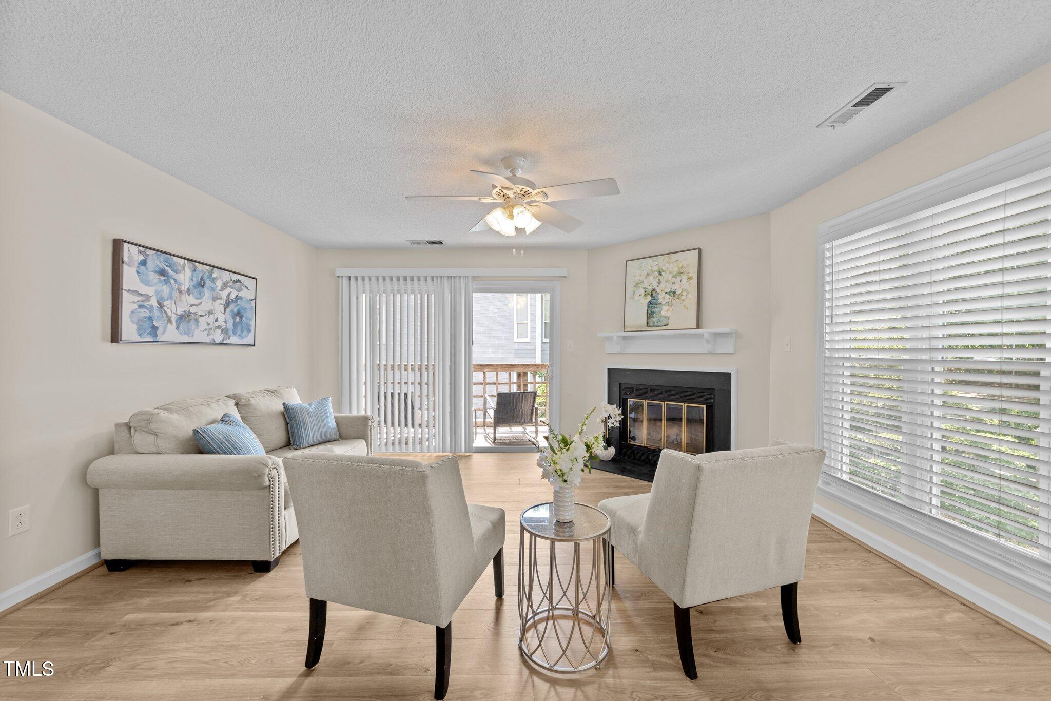 4611 Timbermill Court, Unit 201 Raleigh, NC 27612 - Photo 11 of 32 a living room with furniture and a fireplace