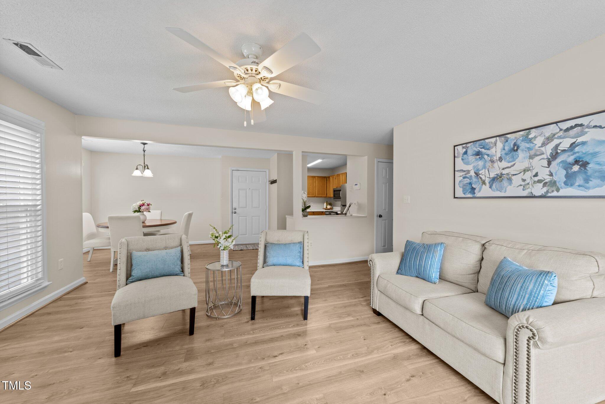 4611 Timbermill Court, Unit 201 Raleigh, NC 27612 - Photo 12 of 32 a living room with furniture and a lamp