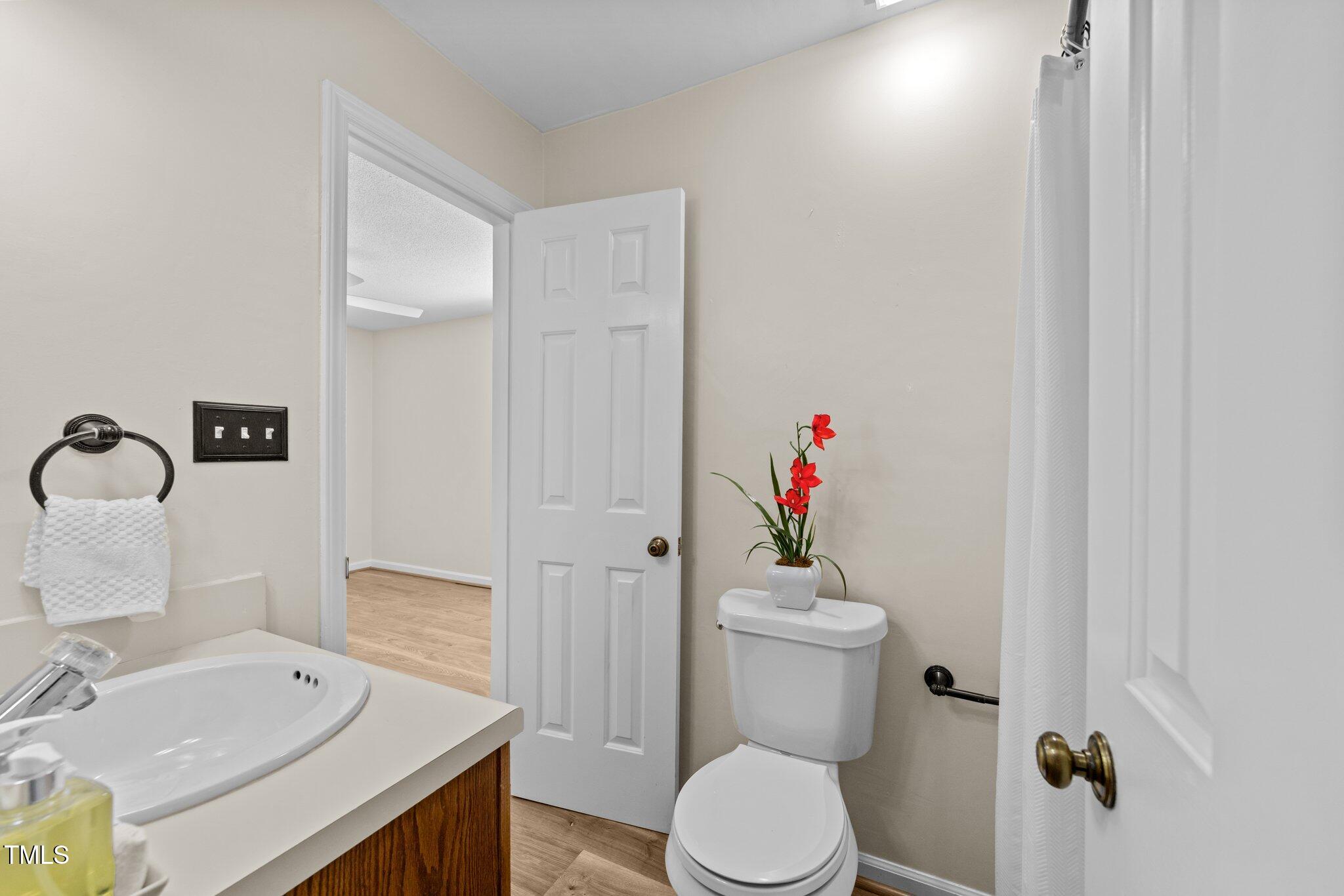4611 Timbermill Court, Unit 201 Raleigh, NC 27612 - Photo 15 of 32 a bathroom with a sink toilet and a mirror