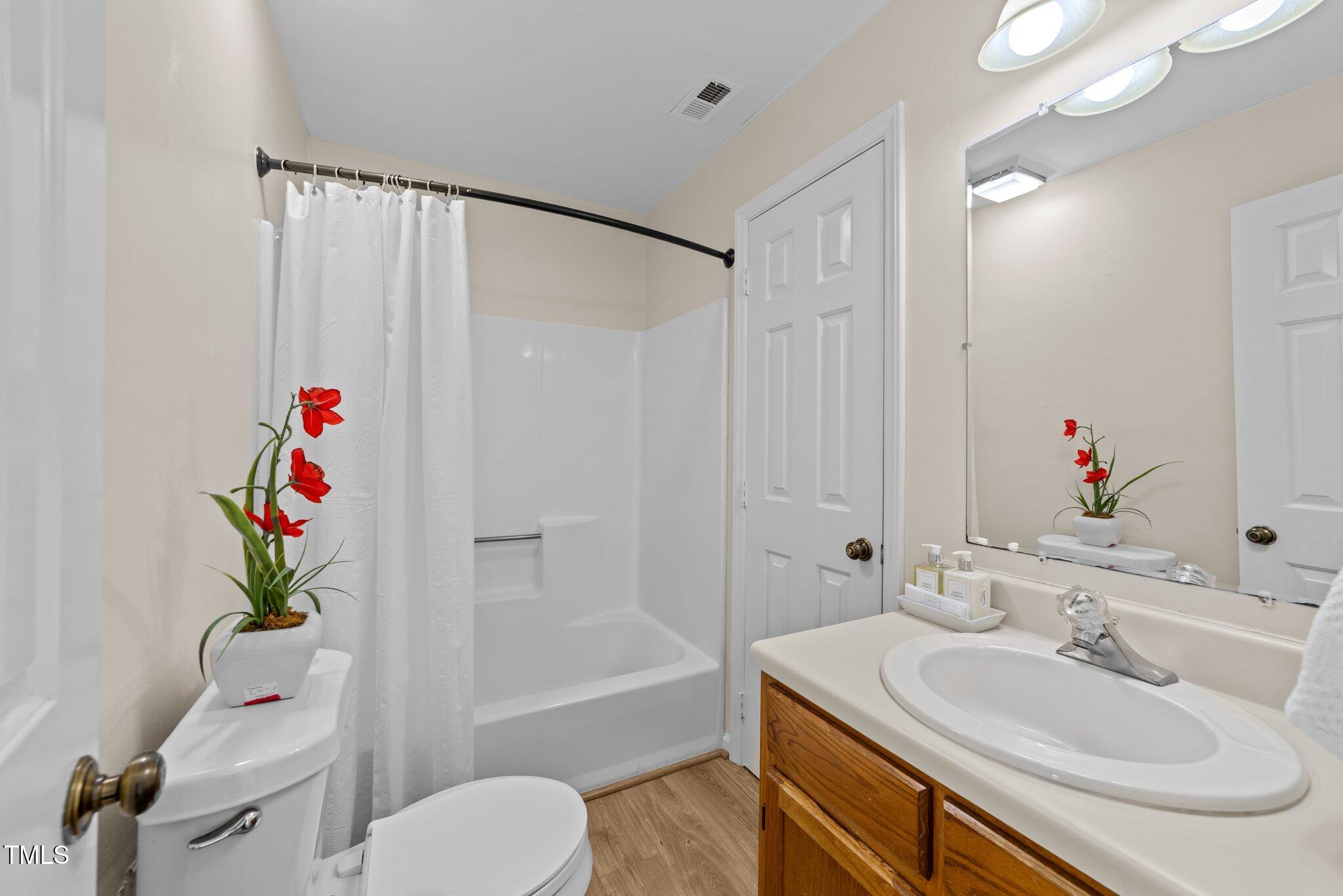 4611 Timbermill Court, Unit 201 Raleigh, NC 27612 - Photo 16 of 32 a bathroom with a sink toilet and shower