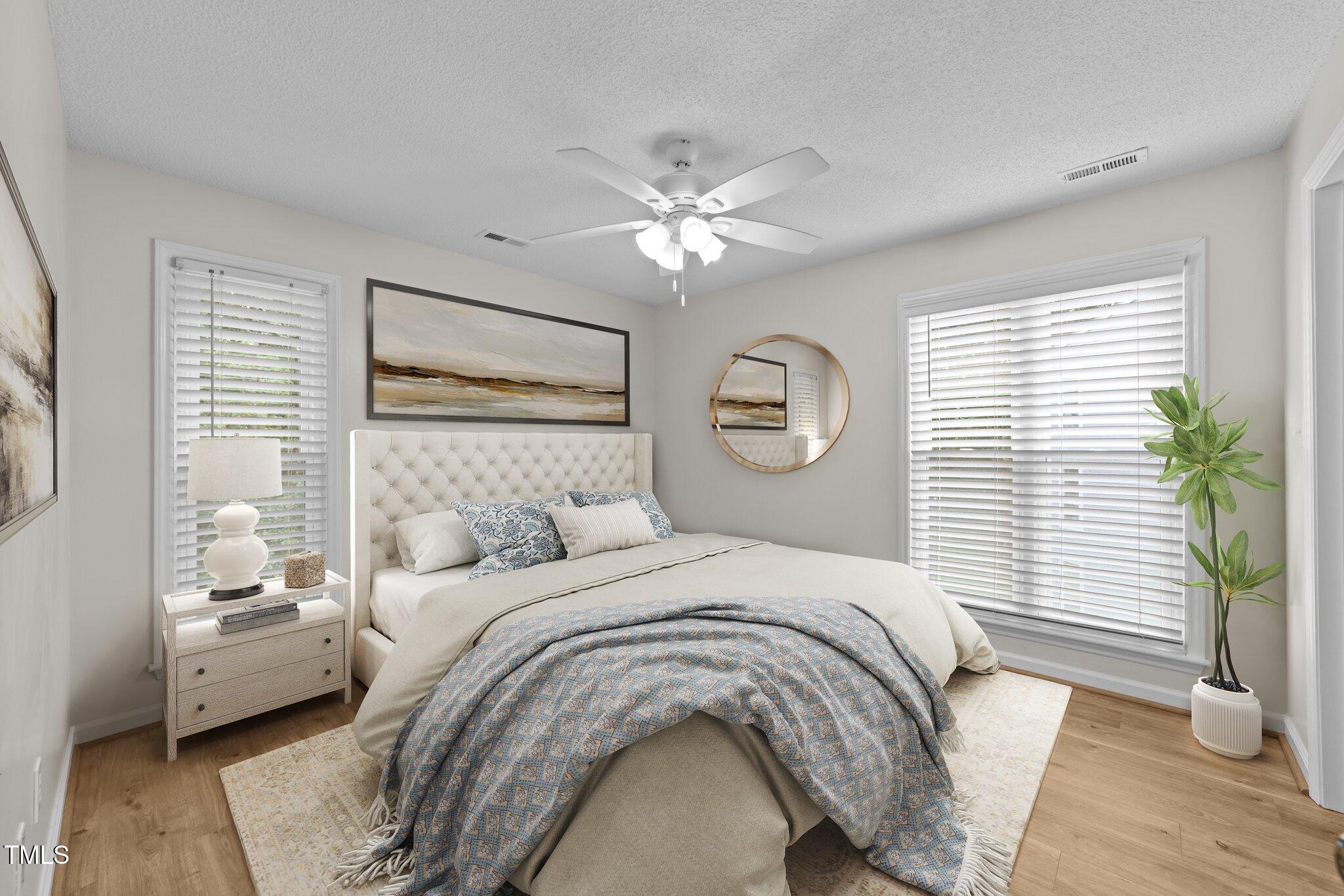 4611 Timbermill Court, Unit 201 Raleigh, NC 27612 - Photo 18 of 32 a bedroom with a large bed and a window