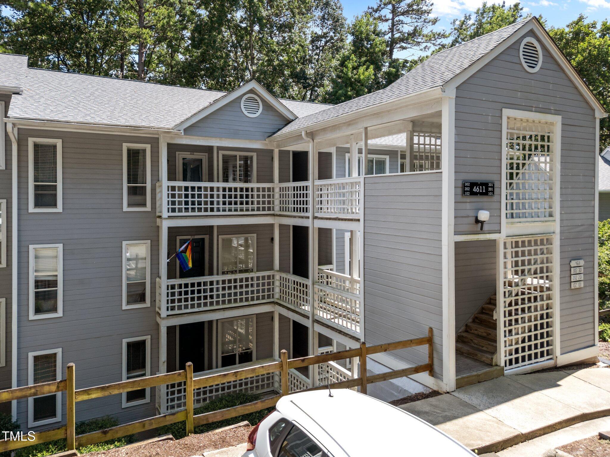 4611 Timbermill Court, Unit 201 Raleigh, NC 27612 - Photo 2 of 32 a front view of a house with a yard
