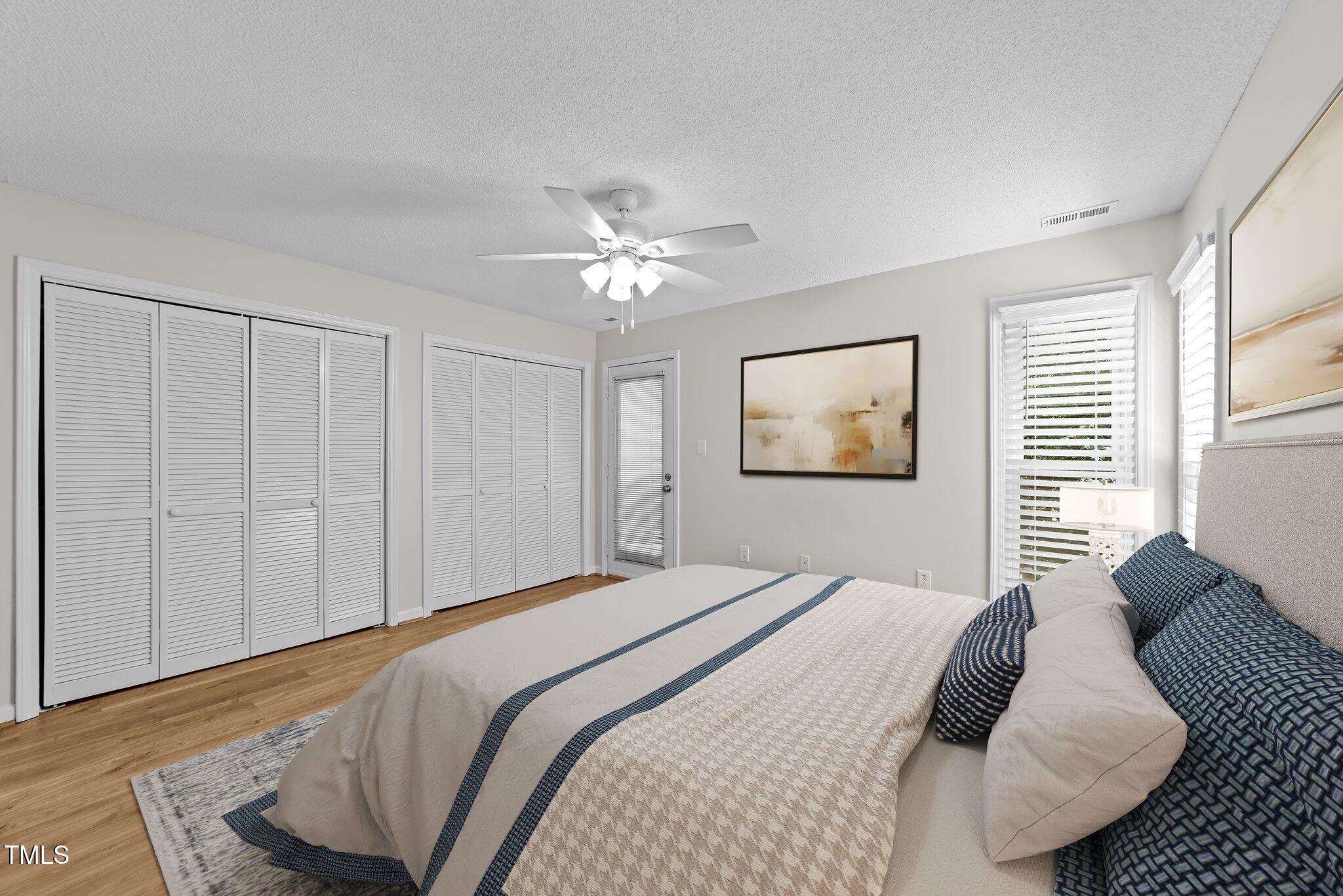 4611 Timbermill Court, Unit 201 Raleigh, NC 27612 - Photo 21 of 32 a bedroom with a large bed and a chandelier