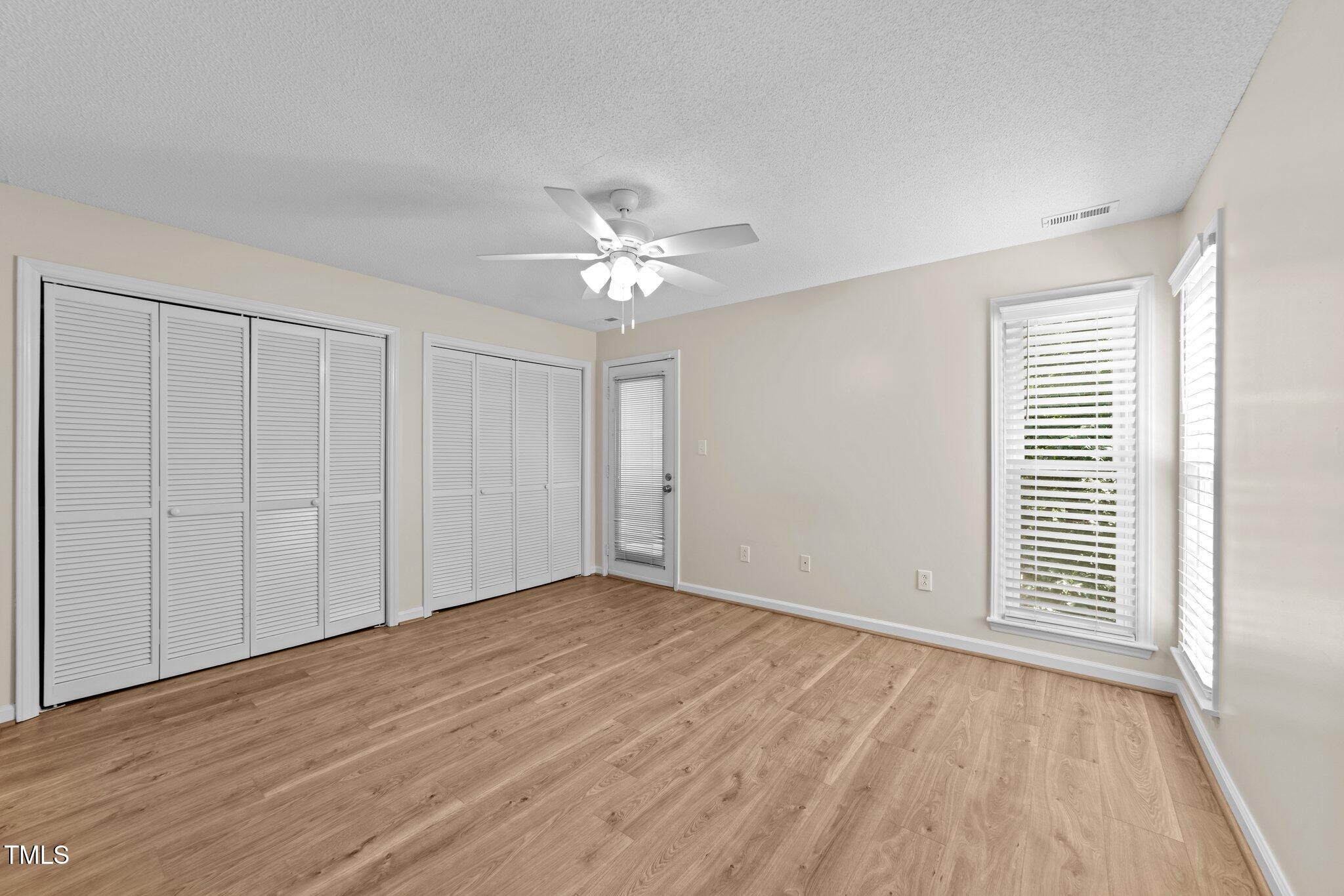 4611 Timbermill Court, Unit 201 Raleigh, NC 27612 - Photo 22 of 32 wooden floor in an empty room with a window