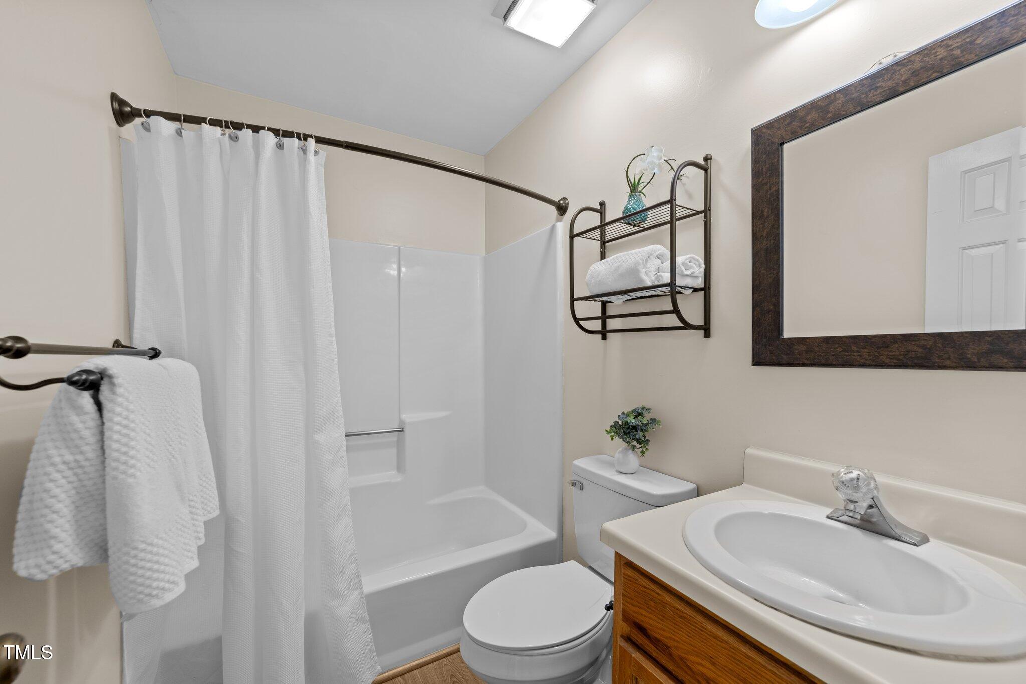 4611 Timbermill Court, Unit 201 Raleigh, NC 27612 - Photo 25 of 32 a bathroom with a sink toilet and shower