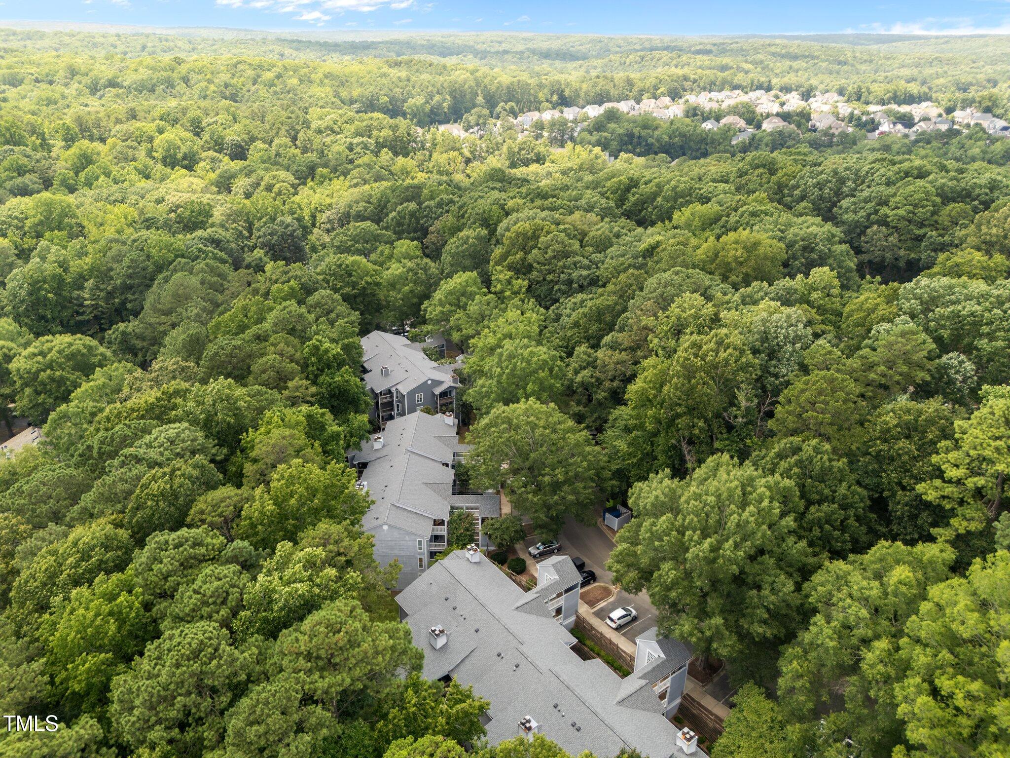 4611 Timbermill Court, Unit 201 Raleigh, NC 27612 - Photo 30 of 32 an aerial view of residential house with parking space and trees