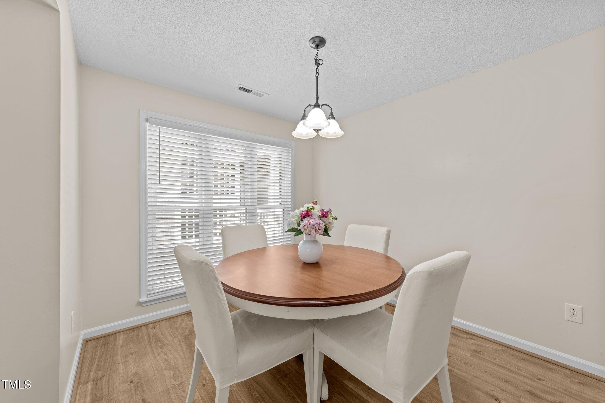4611 Timbermill Court, Unit 201 Raleigh, NC 27612 - Photo 5 of 32 a dining room with furniture and window