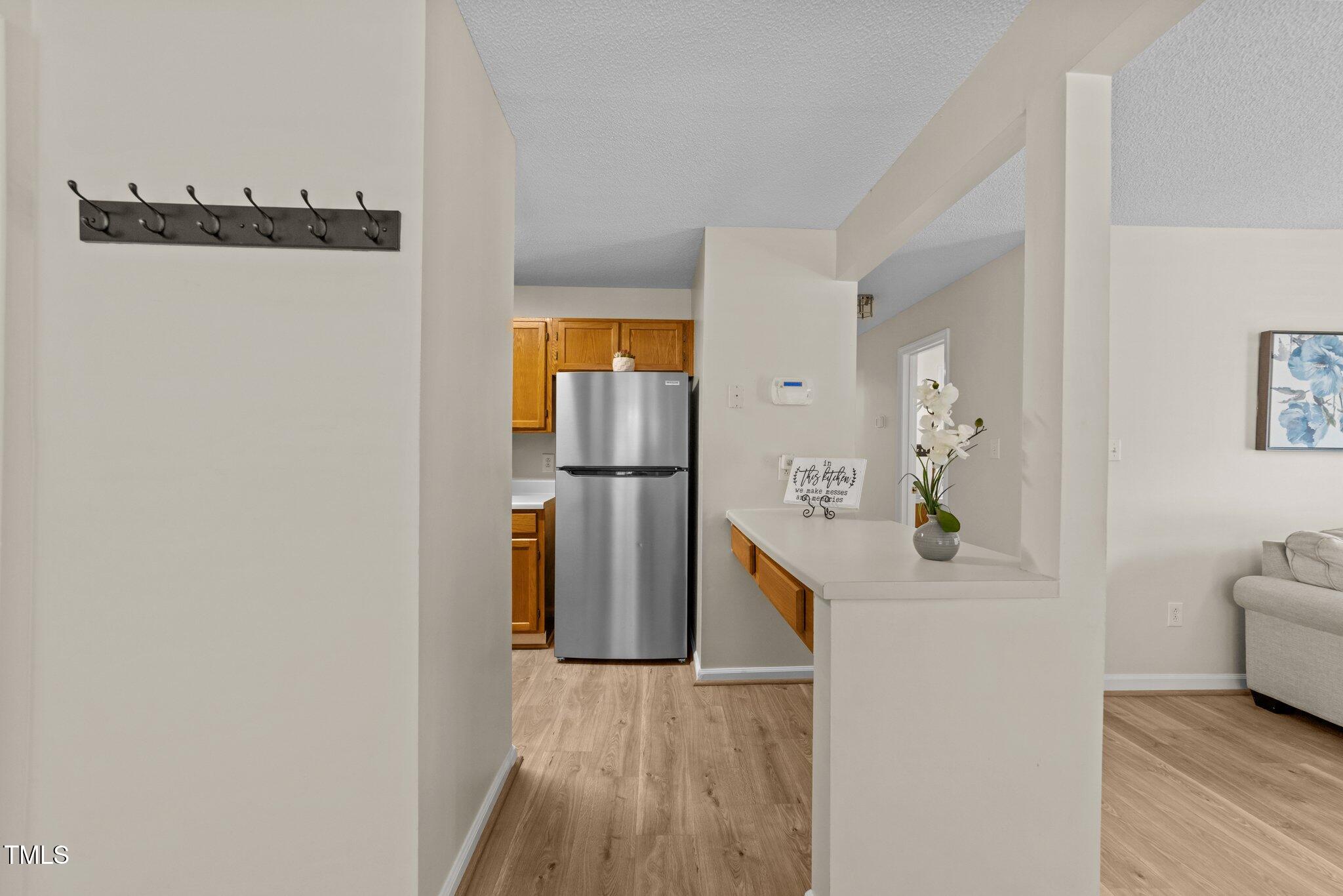 4611 Timbermill Court, Unit 201 Raleigh, NC 27612 - Photo 7 of 32 a view of a kitchen with a refrigerator and a stove