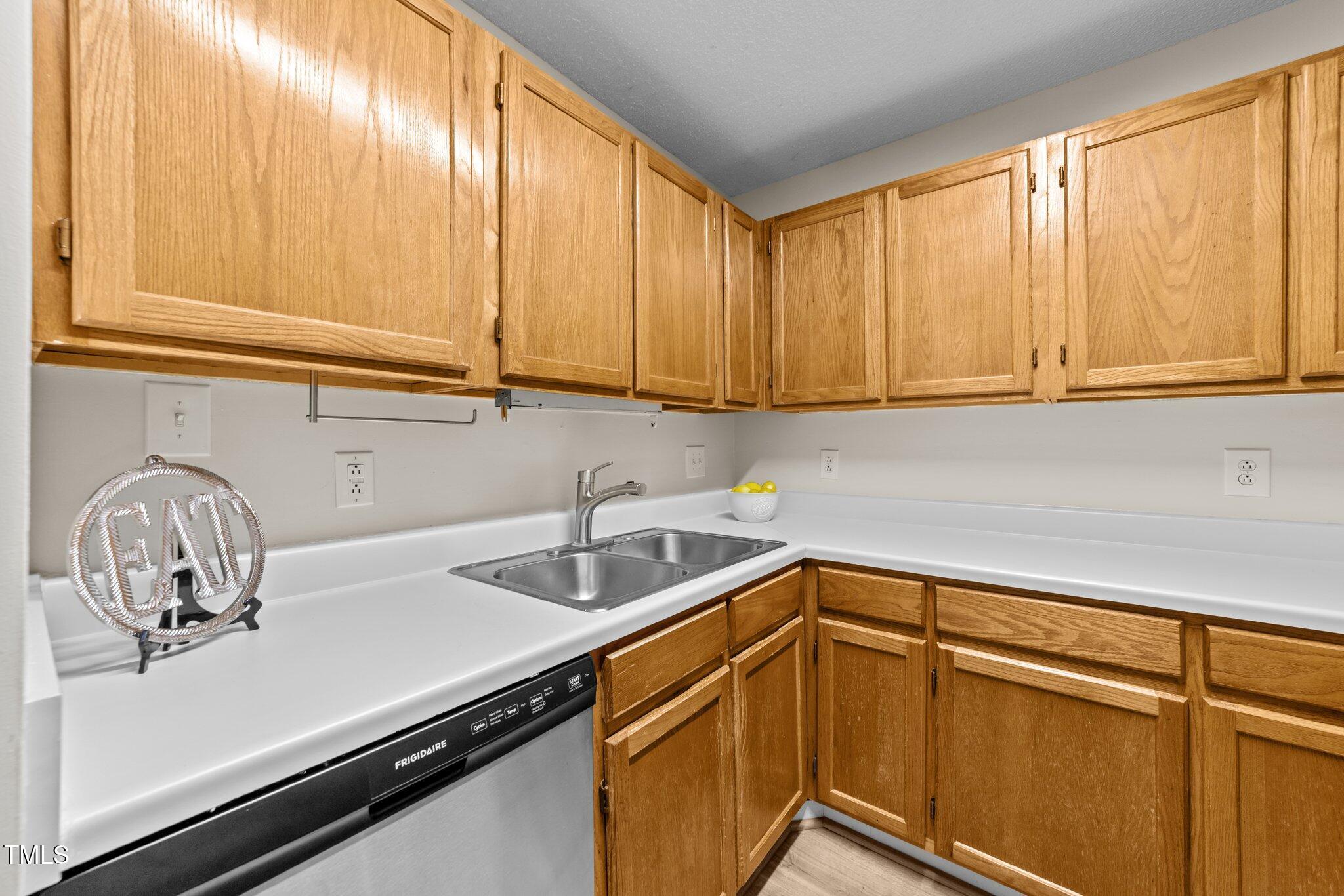 4611 Timbermill Court, Unit 201 Raleigh, NC 27612 - Photo 10 of 32 a kitchen with a sink and cabinets