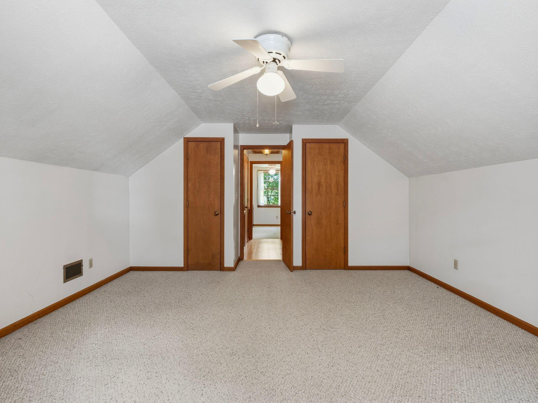 1115 Robin Ridge Road Henry, VA 24102 - Photo 30 of 54 an empty room with chandelier fan and windows