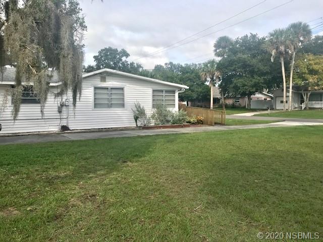 204 Hubbell Street Edgewater, FL 32132 - Photo 12 of 14 a backyard of a house with table and chairs