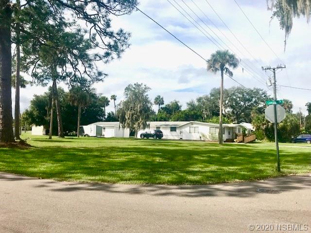 204 Hubbell Street Edgewater, FL 32132 - Photo 7 of 14 a view of a house with a big yard and a large trees