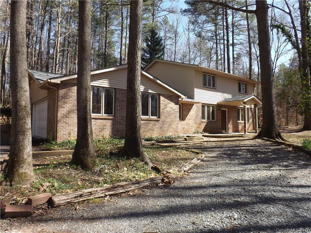 a view of a house with a tree in the background