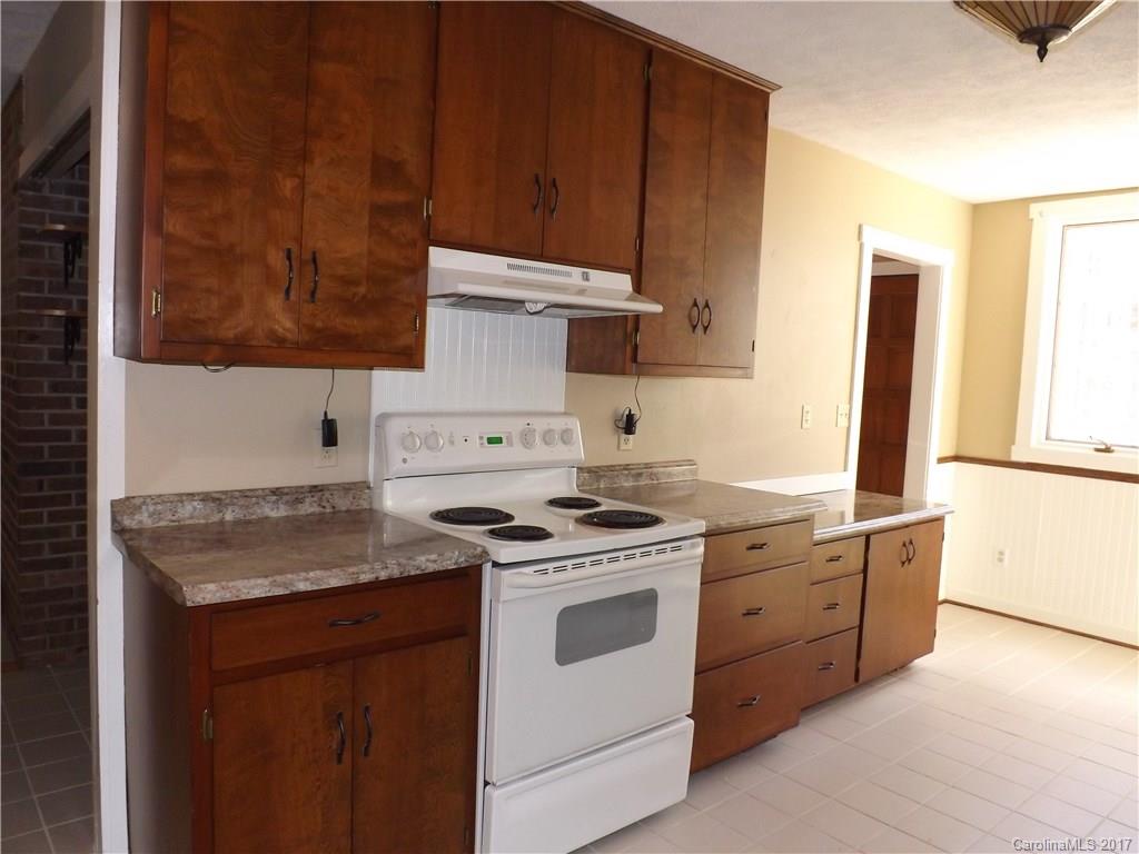 6019 Davis Road Waxhaw, NC 28173 - Photo 2 of 19 a kitchen with a stove top oven sink and cabinets