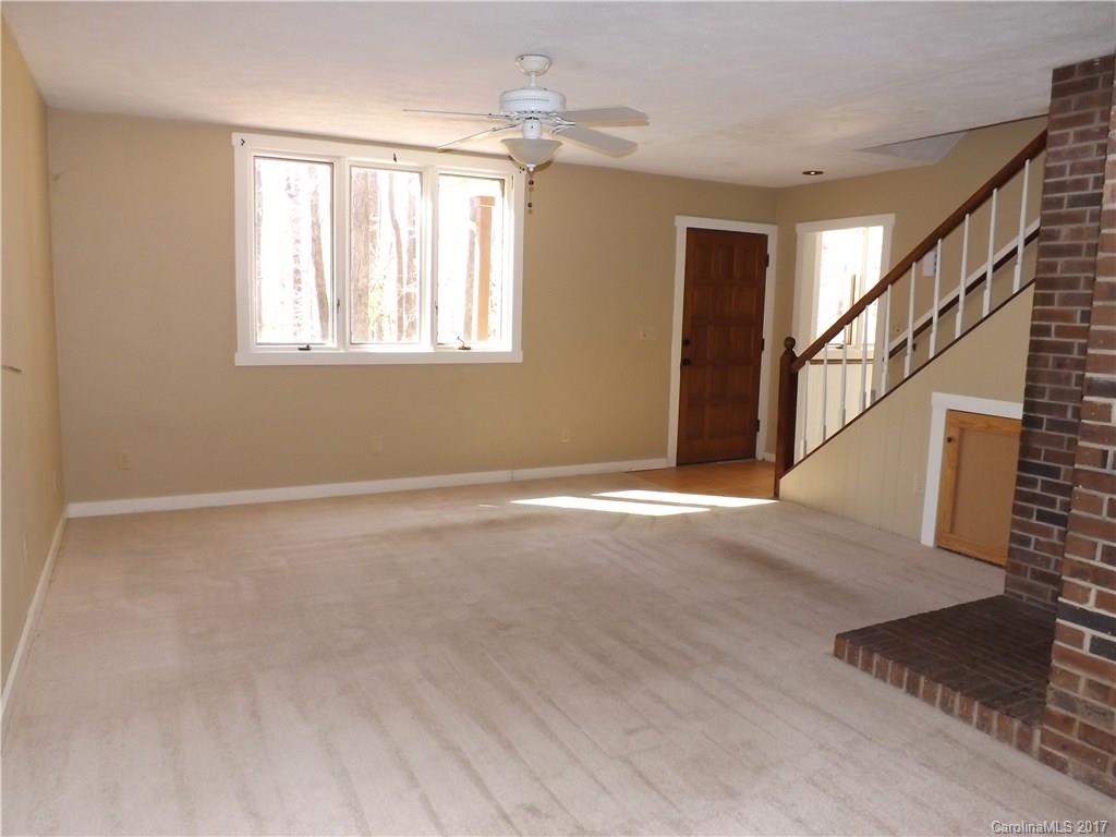 6019 Davis Road Waxhaw, NC 28173 - Photo 11 of 19 a view of an empty room with wooden floor and a window