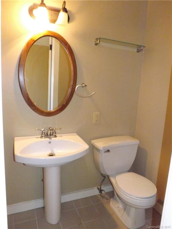 6019 Davis Road Waxhaw, NC 28173 - Photo 17 of 19 a bathroom with a toilet sink and mirror