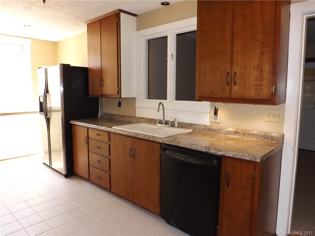 6019 Davis Road Waxhaw, NC 28173 - Photo 3 of 19 a bathroom with a granite countertop sink and a mirror