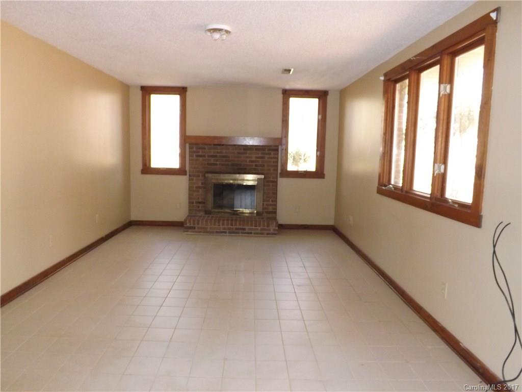 6019 Davis Road Waxhaw, NC 28173 - Photo 6 of 19 a view of empty room with a fireplace and windows