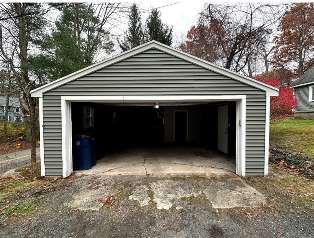 359 Mansfield Street, Unit 1 Sharon, MA 02067 - Photo 11 of 14 a front view of a house with a yard and garage