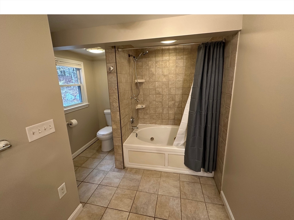 359 Mansfield Street, Unit 1 Sharon, MA 02067 - Photo 12 of 14 a bathroom with a tub a toilet and a shower