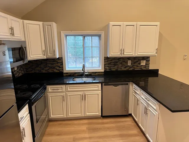 a kitchen with a sink and a refrigerator