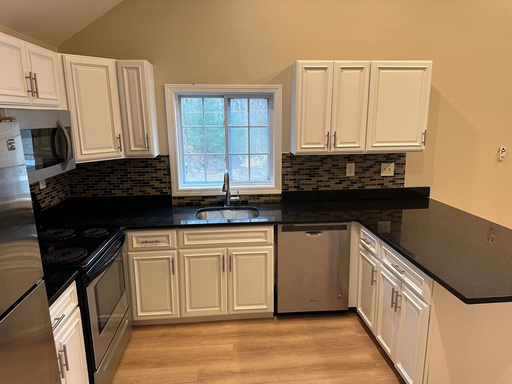 359 Mansfield Street, Unit 1 Sharon, MA 02067 - Photo 3 of 14 a kitchen with a sink and a refrigerator