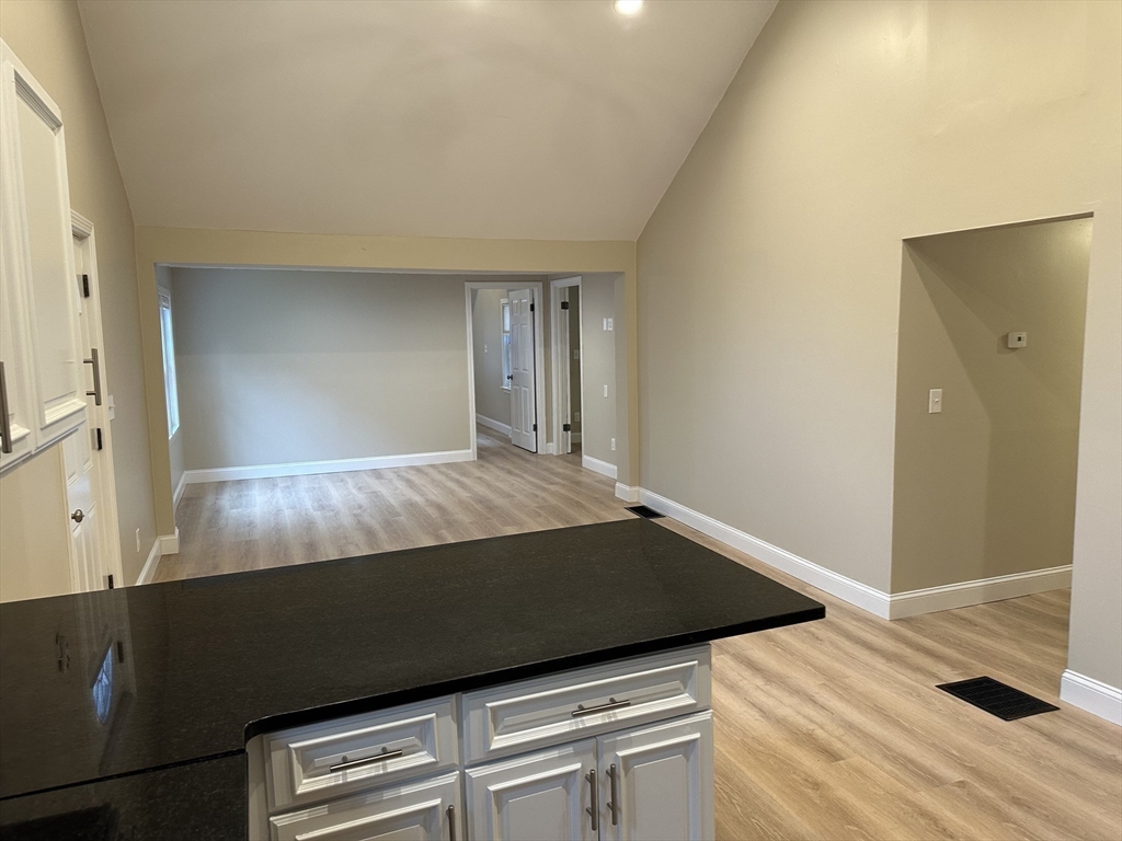 359 Mansfield Street, Unit 1 Sharon, MA 02067 - Photo 5 of 14 a bed sitting in a bedroom next to a window