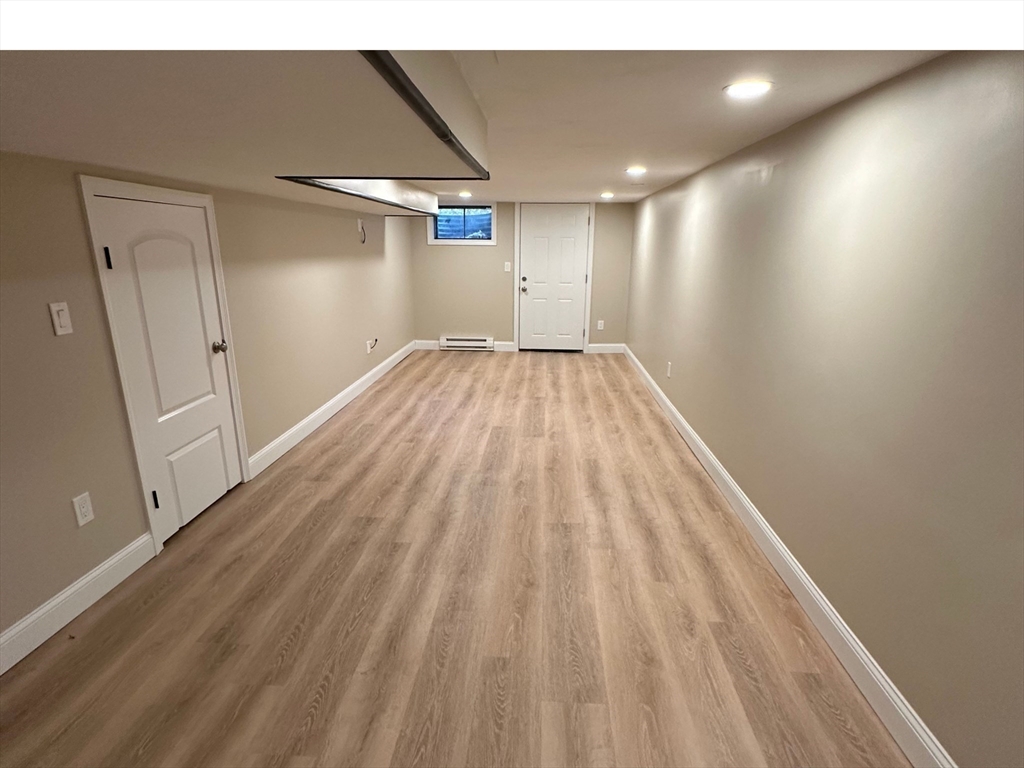 359 Mansfield Street, Unit 1 Sharon, MA 02067 - Photo 9 of 14 a view of empty room with wooden floor