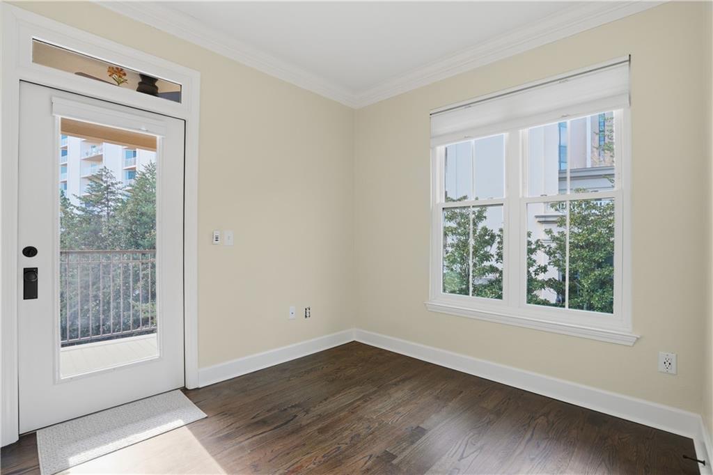 3777 Peachtree Road Northeast, Unit 932 Brookhaven, GA 30319 - Photo 17 of 26 a view of an empty room with wooden floor and a window