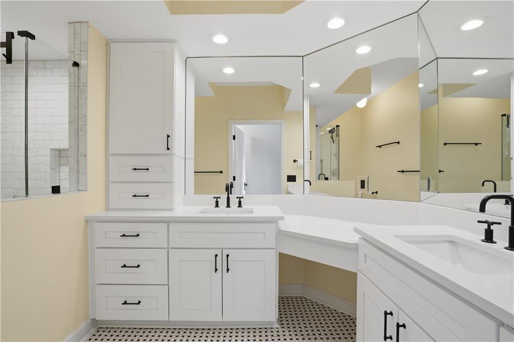 3777 Peachtree Road Northeast, Unit 932 Brookhaven, GA 30319 - Photo 20 of 26 a bathroom with a sink double vanity and a mirror