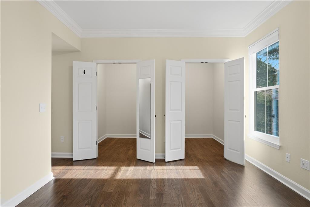 3777 Peachtree Road Northeast, Unit 932 Brookhaven, GA 30319 - Photo 21 of 26 an empty room with wooden floor and windows
