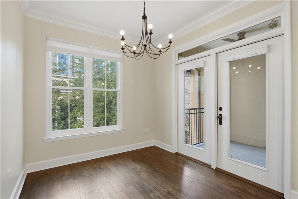 3777 Peachtree Road Northeast, Unit 932 Brookhaven, GA 30319 - Photo 22 of 26 a view of an empty room with wooden floor and a window